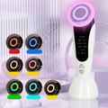 LED facial massager on marble surface