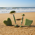 Jade Facial Roller & Gua Sha Set on sea sand